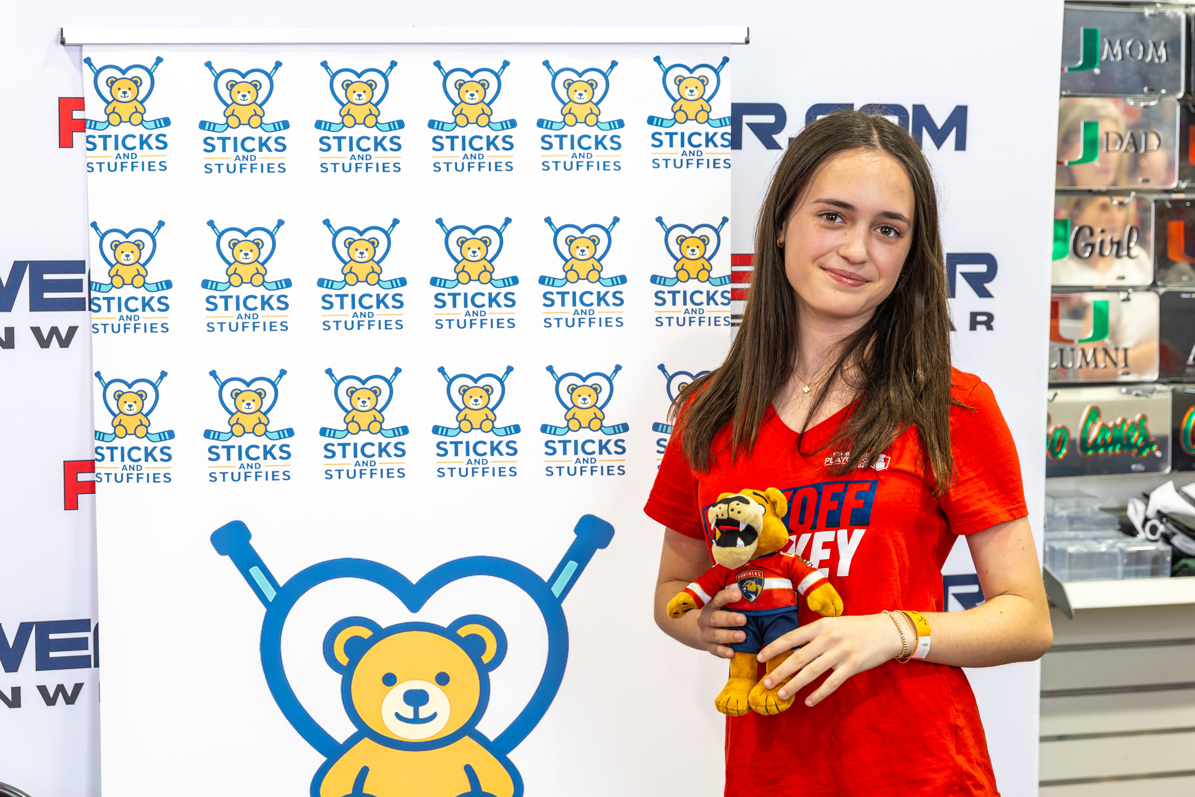 Claire Goodman holding a Stanley C. Panther stuffie at the Sticks and Stuffies event at CanesWear