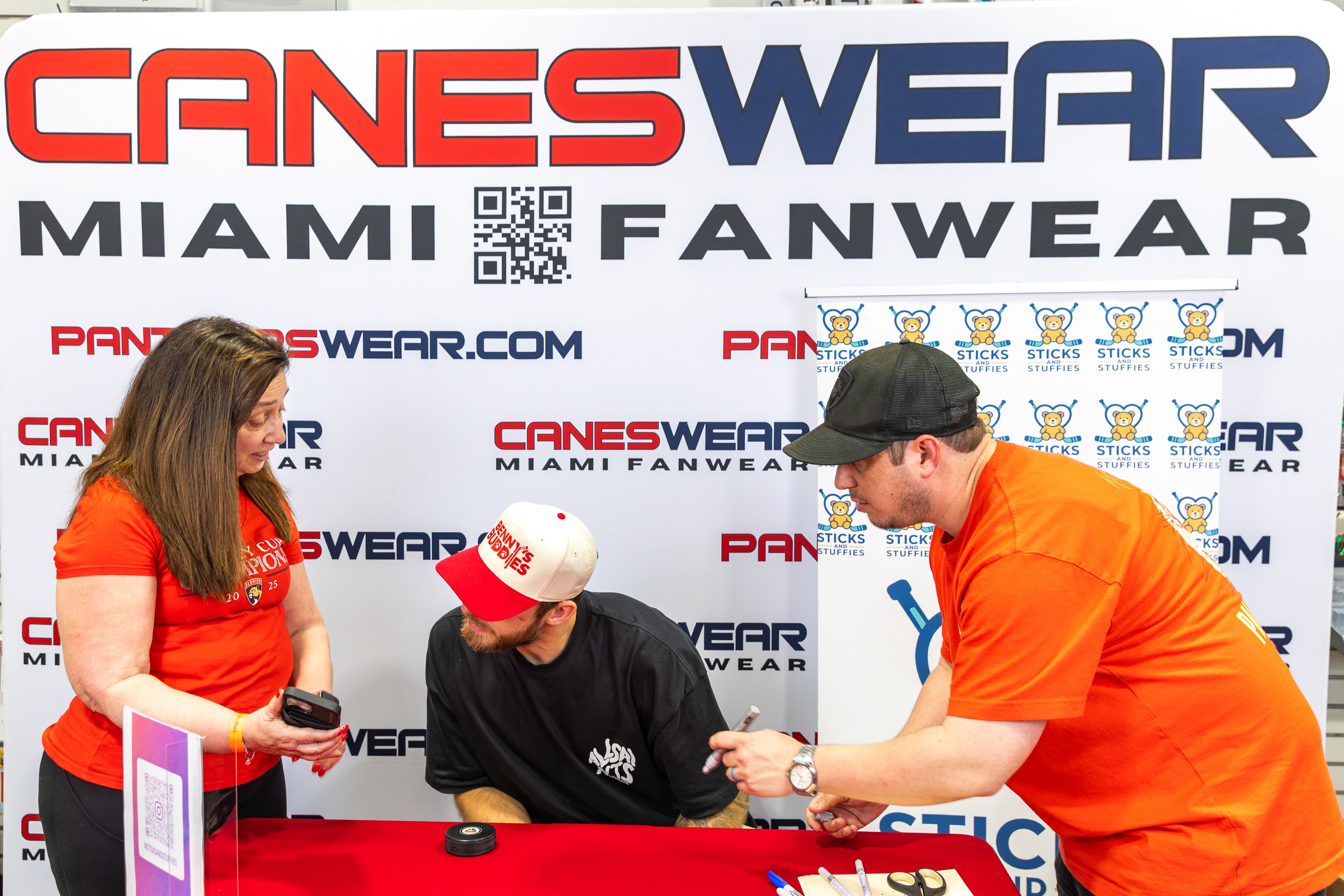 A.J. Greer with a fan at the Sticks and Stuffies signing at CanesWear