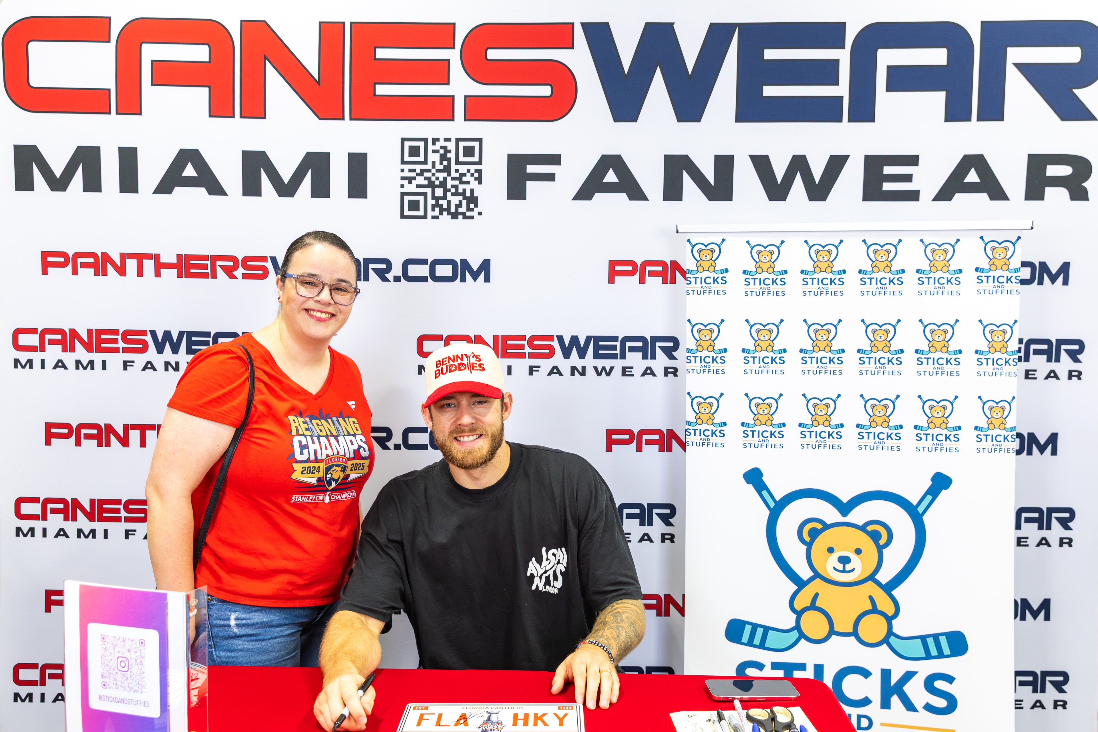 A.J. Greer with a fan at the Sticks and Stuffies signing table