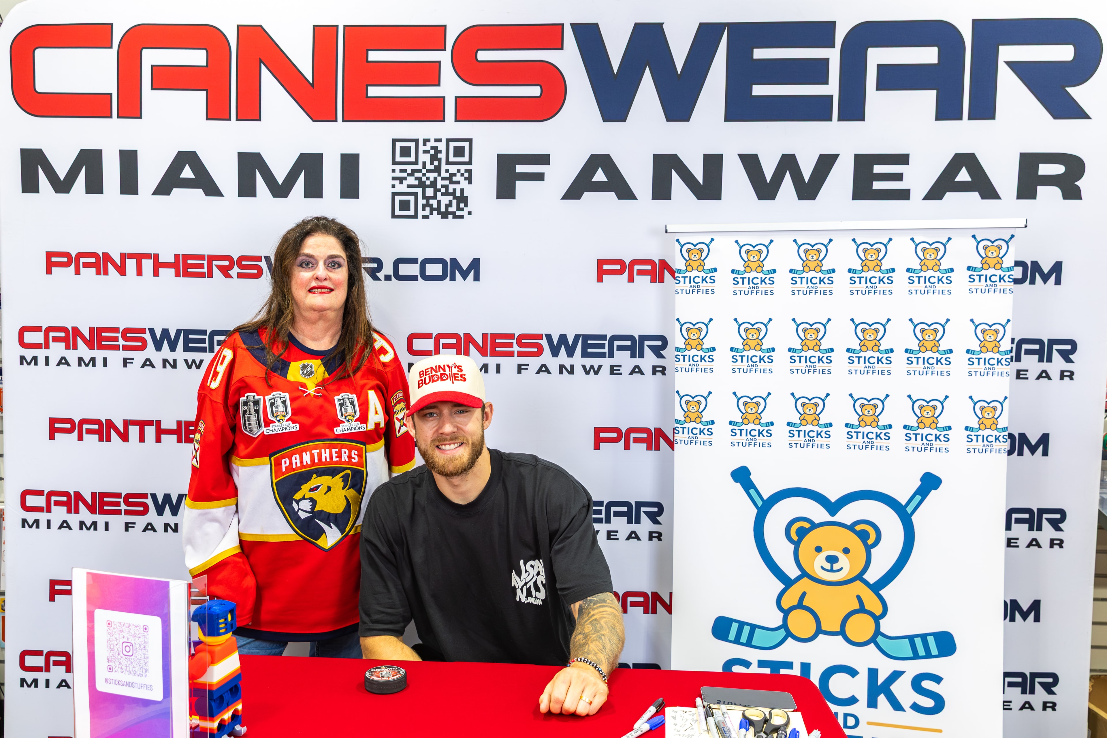 A.J. Greer with a fan at the Sticks and Stuffies signing table at CanesWear