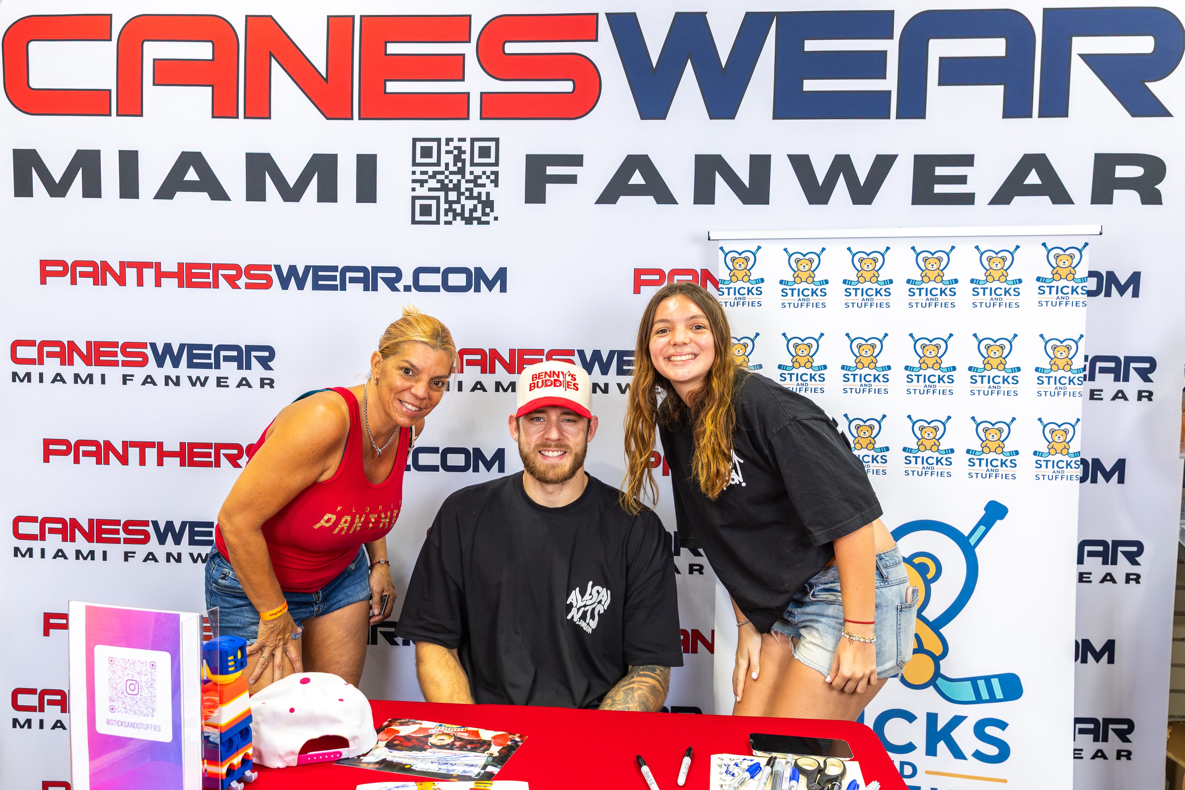 A.J. Greer with two fans at the Sticks and Stuffies signing table at CanesWear