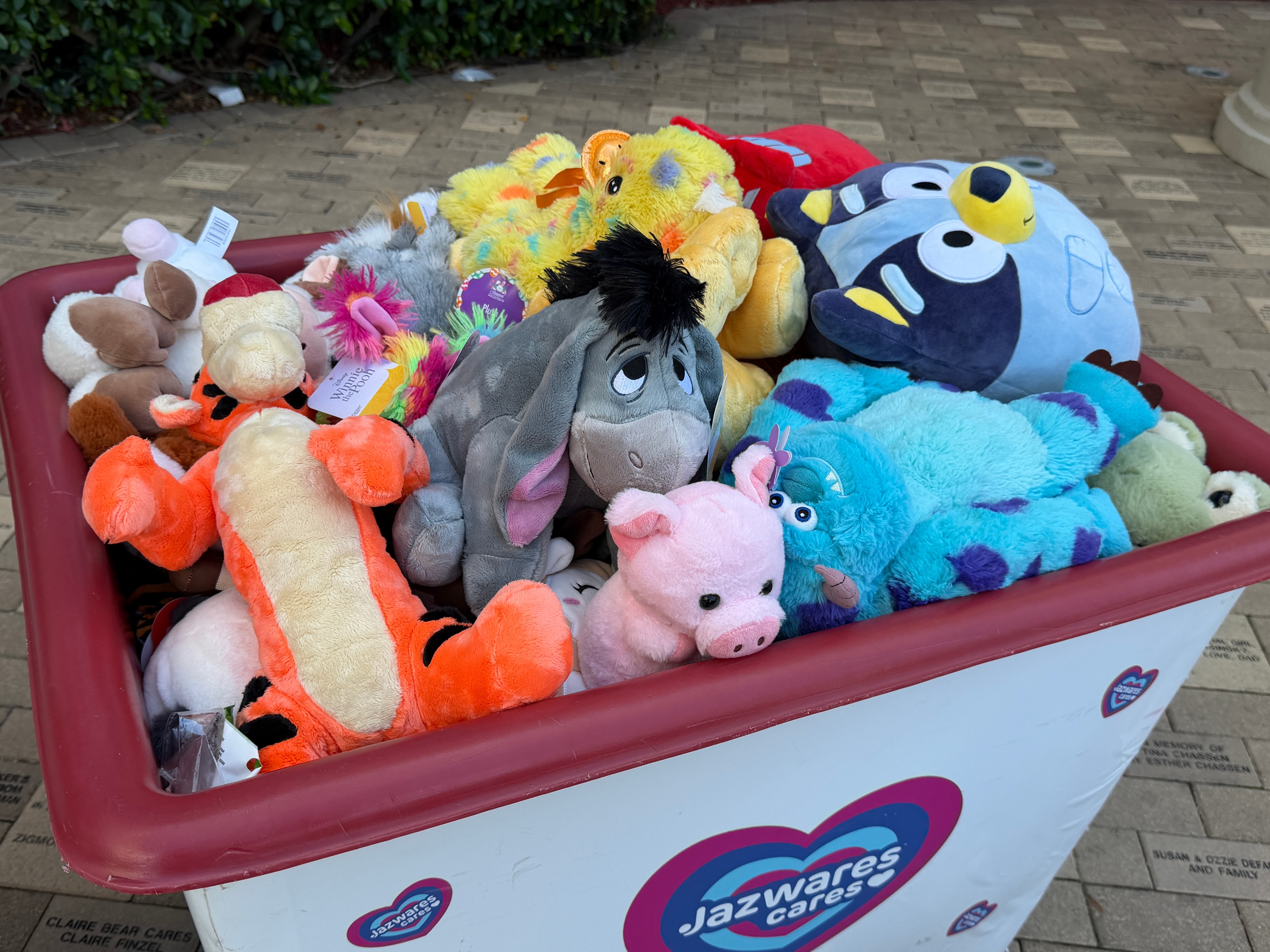 A large donation bin overflowing with colorful new stuffed animals including beloved characters, ready for children at Joe DiMaggio Children's Hospital